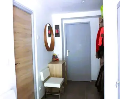 a room with a door and a chair and a mirror at Chalet des Morets in Saint-Gervais-les-Bains