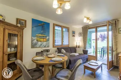 a living room with a table and a couch at Chalet des Morets in Saint-Gervais-les-Bains