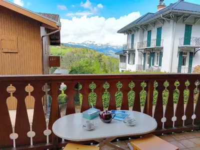 a bedroom with a yellow bed and a balcony at Apartment Isabella by Interhome in Saint-Gervais-les-Bains