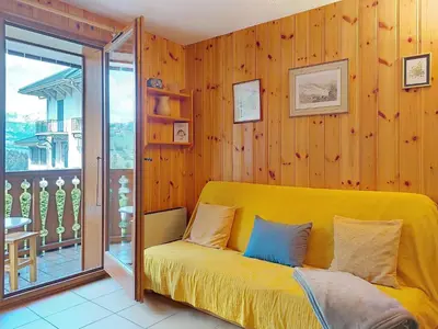 a kitchen with a wooden table and a dining room at Apartment Isabella by Interhome in Saint-Gervais-les-Bains