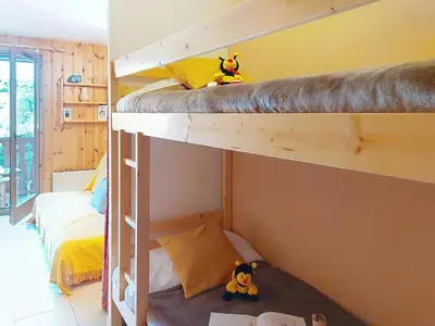 a book and a teddy bear sitting on a bed at Apartment Isabella by Interhome in Saint-Gervais-les-Bains