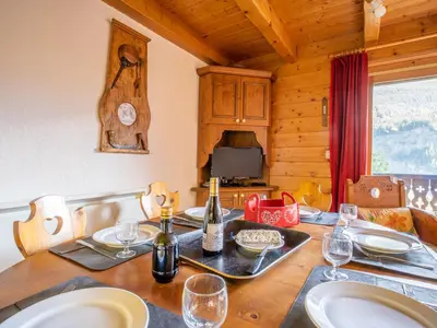 a dining room with a table with wine bottles at Apartment Les Hauts des Chavants -2 by Interhome in Les Houches