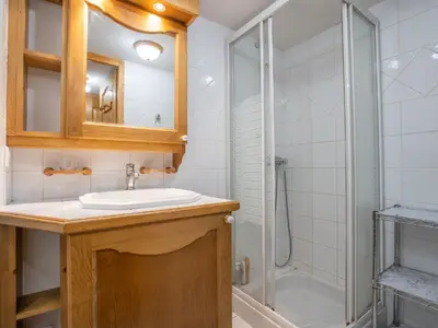 a bathroom with a white sink and a shower at Apartment Les Hauts des Chavants -2 by Interhome in Les Houches