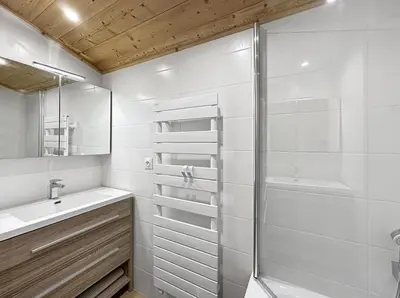a bathroom with a shower and a sink and a mirror at GR450 6 Pers Centre Carroz in Les Carroz d'Araches