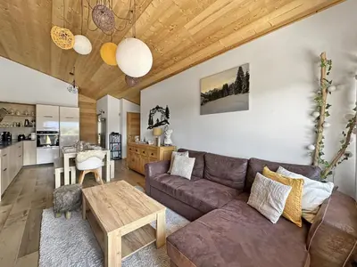a living room with a couch and a table at GR450 6 Pers Centre Carroz in Les Carroz d'Araches