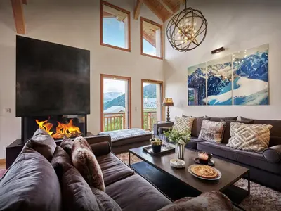 a living room with a couch and a fireplace at Chalet Etoile Nordique - OVO Network in Saint-Gervais-les-Bains