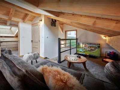 a living room with a couch and a flat screen tv at Chalet Etoile Nordique - OVO Network in Saint-Gervais-les-Bains