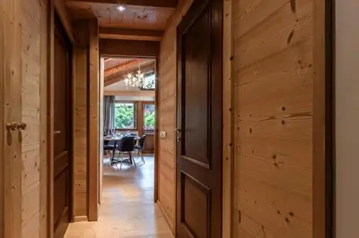 an open hallway with wooden walls and a dining room at Grand Balcon 3 - Calme - Vues - Cosy in Les Houches