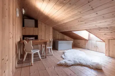 a wooden room with a table and chairs and a rug at Grand Balcon 3 - Calme - Vues - Cosy in Les Houches