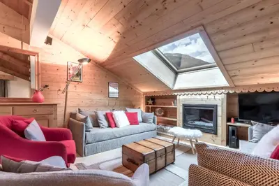 a living room with a skylight in a wooden house at Grand Balcon 3 - Calme - Vues - Cosy in Les Houches