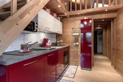 a kitchen with red cabinets and a red refrigerator at Grand Balcon 3 - Calme - Vues - Cosy in Les Houches