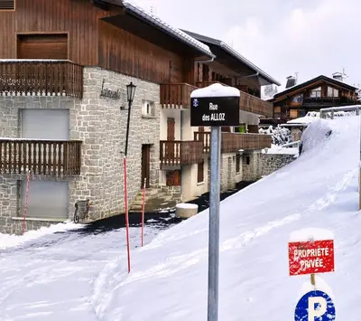 a sign in the snow in front of a building at Le Farniente - Central - Chaleureux in Megève