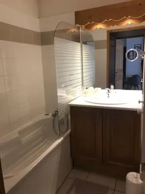 a bathroom with a tub and a sink and a bath tub at Appt MIAGE - 2 pièces cabine, terrasse & piscine in Saint-Gervais-les-Bains