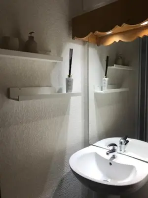 a bathroom with a white sink and a toilet at Appt MIAGE - 2 pièces cabine, terrasse & piscine in Saint-Gervais-les-Bains