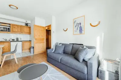 a living room with a couch and a table at Appt MIAGE - 2 pièces cabine, terrasse & piscine in Saint-Gervais-les-Bains