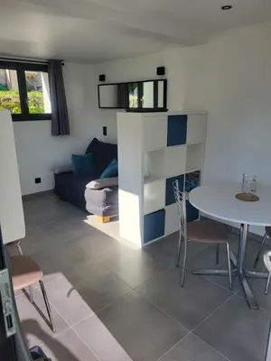 a living room with a table and a couch at Studio Saint Antoine Les Houches in Les Houches