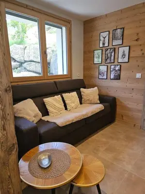a living room with a couch and a table at Charmant T1 montagnard proche télécabine in Saint-Gervais-les-Bains