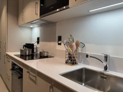 a kitchen with a sink and a counter top at Le lodge de l alpage - Ski in ski out - 2 chambres 1 cabine in Combloux