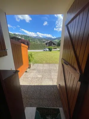 an open door with a view of a yard at le jaillet in Megève