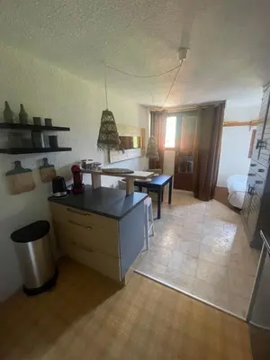 a living room with a kitchen and a dining room at le jaillet in Megève