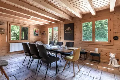 a dining room with a table and chairs at Balcon De l Europe - Jacuzzi prive - Vues in Les Houches