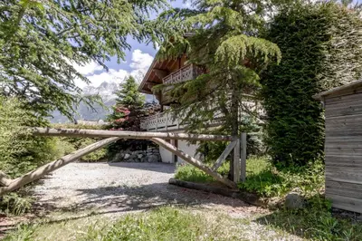 a gate to a house with a wooden fence at Balcon De l Europe - Jacuzzi prive - Vues in Les Houches