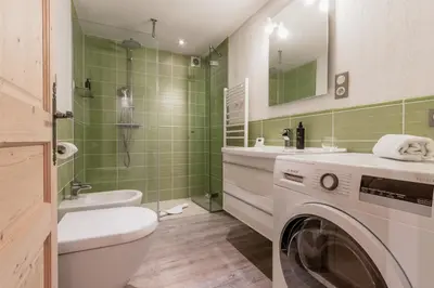 a bathroom with a washer and a washing machine at Balcon De l Europe - Jacuzzi prive - Vues in Les Houches
