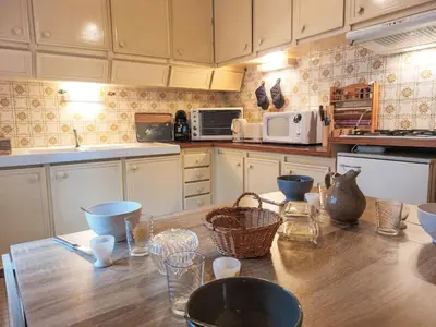 a kitchen with a wooden table with baskets on it at Apartment La côte du Parc-1 by Interhome in Saint-Gervais-les-Bains