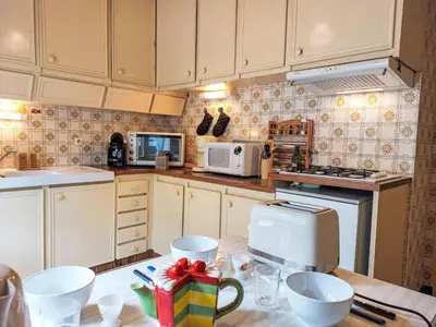 a kitchen with a white refrigerator and a stove at Apartment La côte du Parc-1 by Interhome in Saint-Gervais-les-Bains
