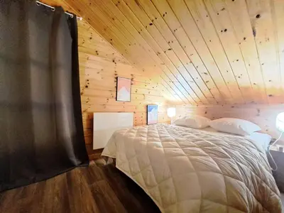 a bed in a room with a wooden ceiling at Les Chalets de Flaine Hameau - maeva Home - Chalet 5 Pièces 10 Personnes - Exclusive MAE-0944 in Flaine