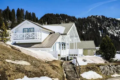 a white house on a hill with snow at Les Chalets de Flaine Hameau - maeva Home - Chalet 5 Pièces 10 Personnes - Exclusive MAE-0944 in Flaine