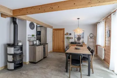 a kitchen and dining room with a wooden table and chairs at Les Chalets de Flaine Hameau - maeva Home - Chalet 5 Pièces 10 Personnes - Exclusive MAE-0944 in Flaine