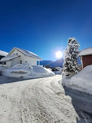 a snow covered road with a house and a tree at Les Chalets de Flaine Hameau - maeva Home - Chalet 5 Pièces 10 Personnes - Exclusive MAE-0944 in Flaine