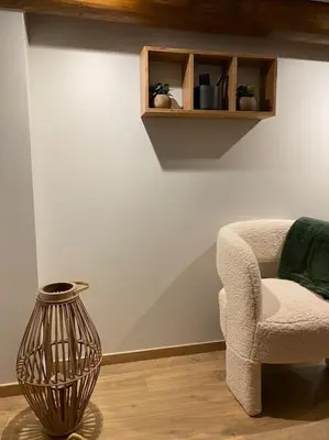 a living room with a chair and a vase at Appartement Brévent in Les Houches