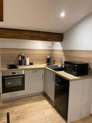 a kitchen with a microwave oven and a stove at Appartement Brévent in Les Houches