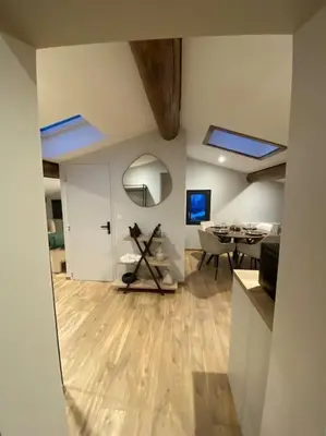 a living room with a dining area and a room with a table at Appartement Brévent in Les Houches