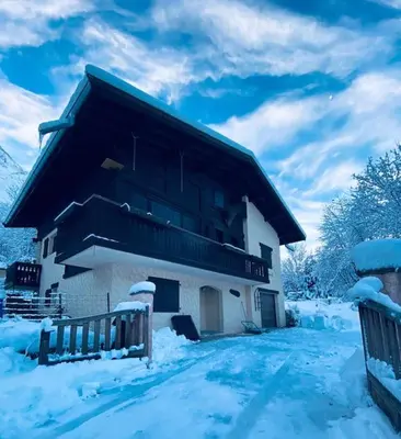 a building with snow on the side of it at Appartement Brévent in Les Houches