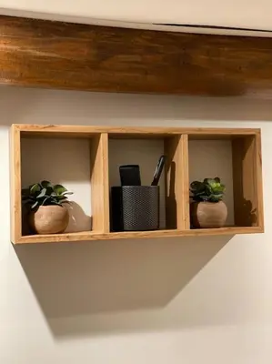 a wooden shelf with three plants on it at Appartement Brévent in Les Houches