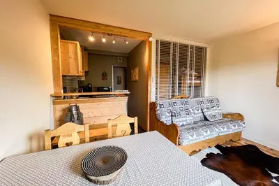a living room with a couch and a table at Comfortable studio with pool and view in Saint-Gervais-les-Bains
