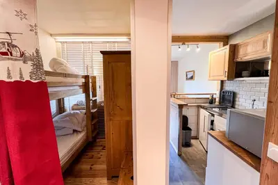 a small kitchen with a bunk bed in a room at Comfortable studio with pool and view in Saint-Gervais-les-Bains