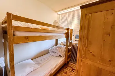 a bunk bed room with two bunk beds and a window at Comfortable studio with pool and view in Saint-Gervais-les-Bains