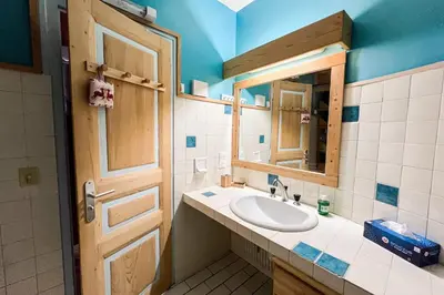 a bathroom with a sink and a mirror at Comfortable studio with pool and view in Saint-Gervais-les-Bains