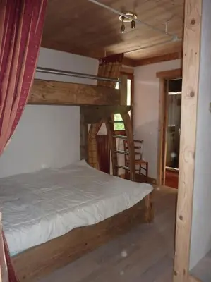 a bedroom with a bunk bed in a room at Premier étage d'une ferme rénovée in Passy
