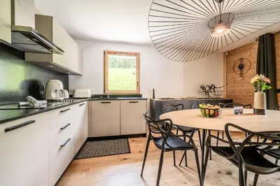 a kitchen with a table and chairs in a room at Apartment Lupin Megève - by EMERALD STAY in Megève