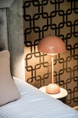 a lamp sitting on a table next to a bed at Apartment Lupin Megève - by EMERALD STAY in Megève