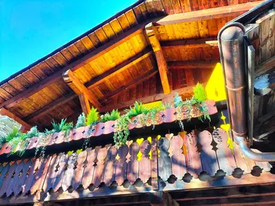 a wooden fence with potted plants on it at Three Bedroom Chalet Lemon Pit Chamonix in Chamonix-Mont-Blanc