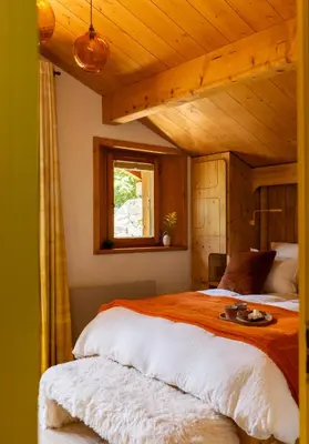 a bedroom with a large bed with a wooden ceiling at Three Bedroom Chalet Lemon Pit Chamonix in Chamonix-Mont-Blanc