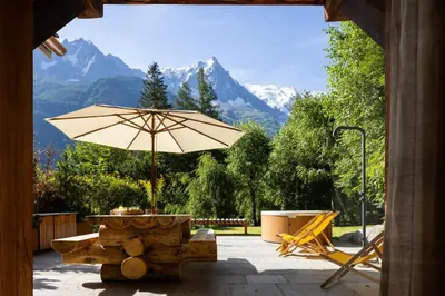 a patio with a table and an umbrella at Three Bedroom Chalet Lemon Pit Chamonix in Chamonix-Mont-Blanc