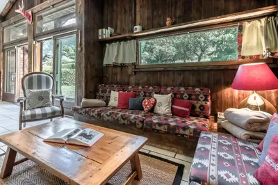 a living room with a couch and a table at La Poya haut - Calme - Vues magnifiques in Les Houches