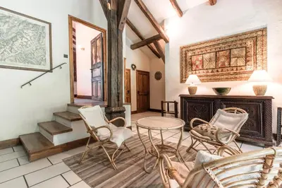 a living room with a table and chairs and a fireplace at La Poya haut - Calme - Vues magnifiques in Les Houches